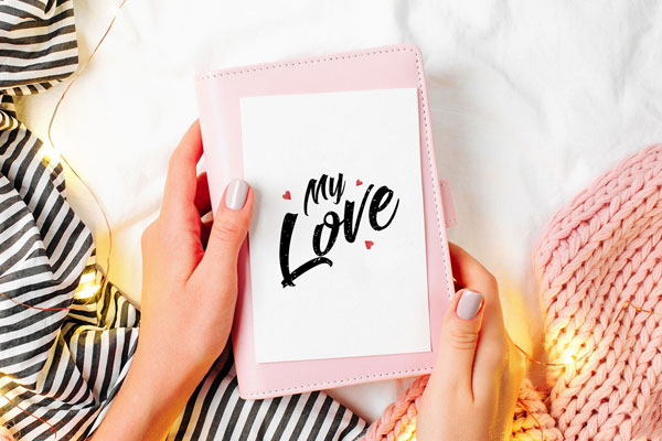 Top View of Girl Holding a Greeting Card Mockup