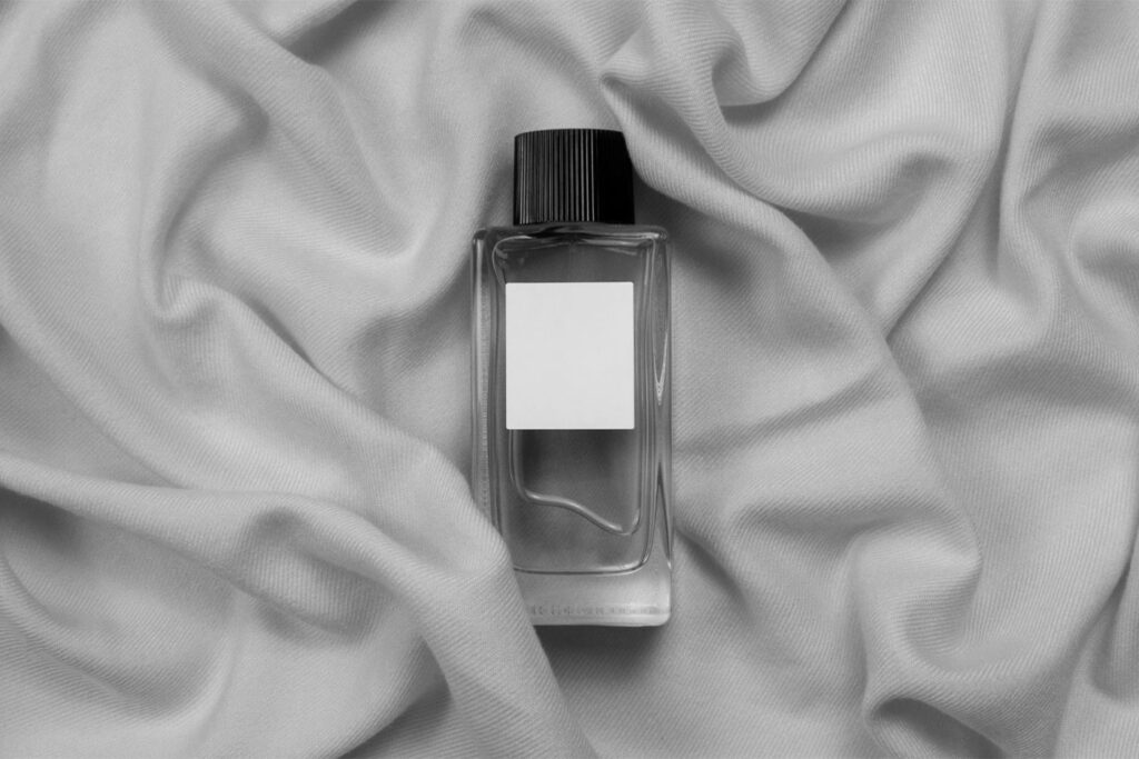 Top View of Glass Bottle Perfume Mockup on Fabric