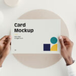 Top View of Hands Holding a Card Mockup