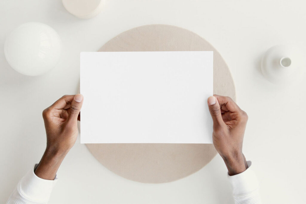 Top View of Hands Holding a Card Mockup