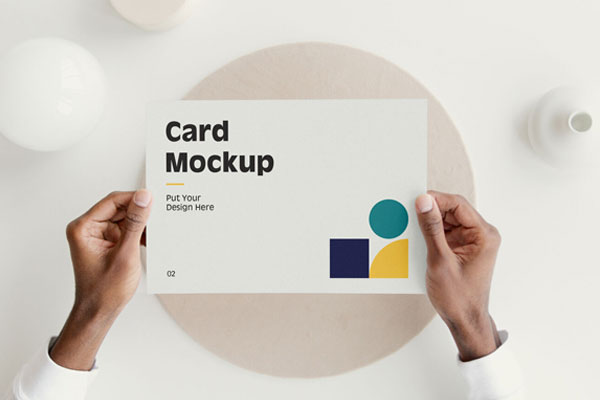 Top View of Hands Holding a Card Mockup