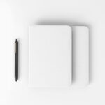 Top View of Notebook Mockup with Pen