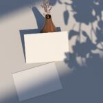 Top View of Postcard Mockup Against the Rustic Vase