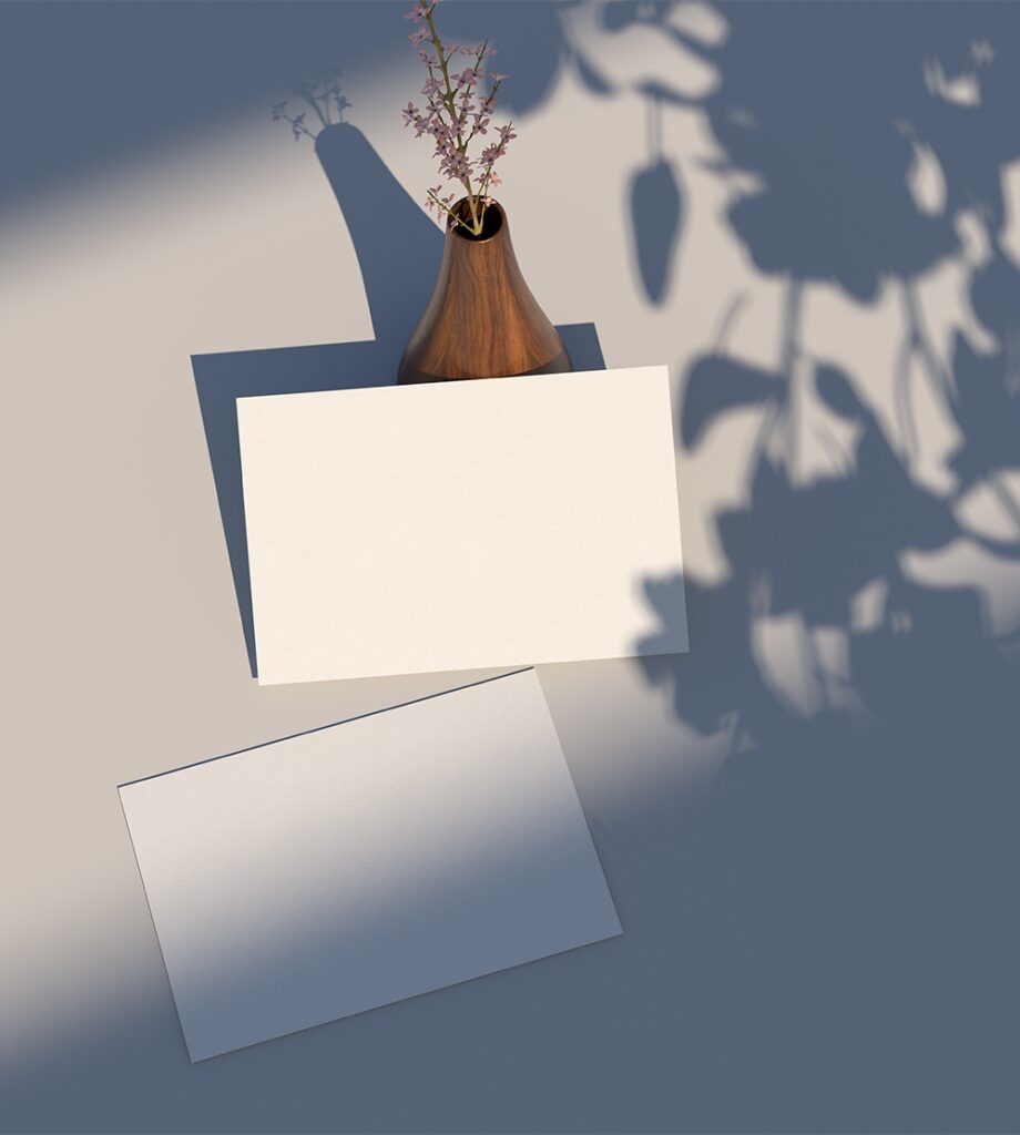 Top View of Postcard Mockup Against the Rustic Vase