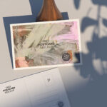 Top View of Postcard Mockup Against the Rustic Vase