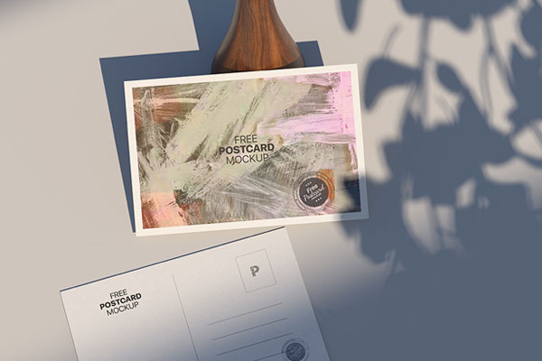 Top View of Postcard Mockup Against the Rustic Vase