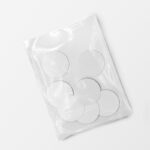 Top View of Seven Round Stickers in a Plastic Wrapping Mockup