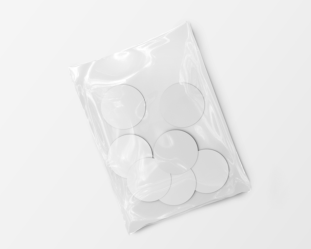 Top View of Seven Round Stickers in a Plastic Wrapping Mockup