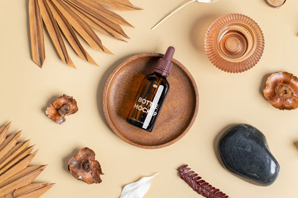 Top View of Small Dropper Bottle Mockup on Wooden Plate