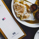 Top View of Tall Restaurant Menu Mockup on Dining Table