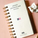 Top View of Vertical Spiral Notebook Mockup with Scrambled Papers