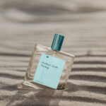 Transparent Perfume Bottle Mockup on Sunny Beach