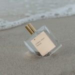 Transparent Perfume Bottle with Label Mockup in Beach