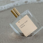 Transparent Perfume Bottle with Label Mockup in Beach