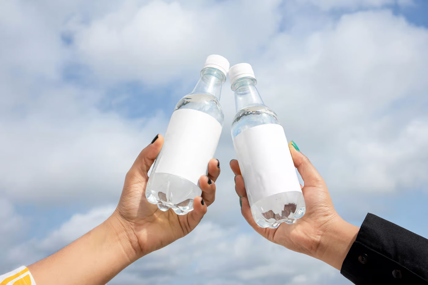 Free Two Bottle in Hand Mockups PSD Template