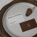 Two Business Cards on a Plate with a Little Rock Mockup