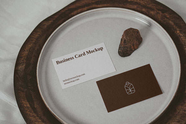 Two Business Cards on a Plate with a Little Rock Mockup