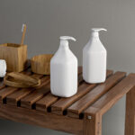 Two Cosmetic Pump Bottles on Wooden Table Mockup