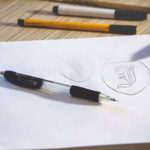 Two Logo Sketch on White Paper Mockups