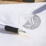 Two Logo Sketch on White Paper Mockups