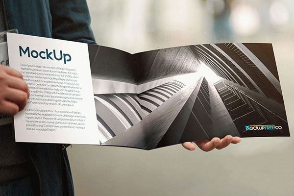 Two Mockups Featuring Man Holding Opened and Closed Booklets