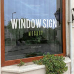 Two Mockups Featuring Perspective Views of Two Restaurant Window Signs