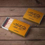 Two Mockups of Match Boxes on Wooden Surface