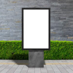 Vertical City Signage Standing on Sidewalk in the Front View Mockup