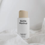Vertical Cream Bottle on Fabric Mockup