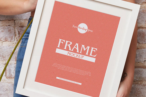 Vertical Photo Frame Mockup Featuring a Girl Holding it Diagonally