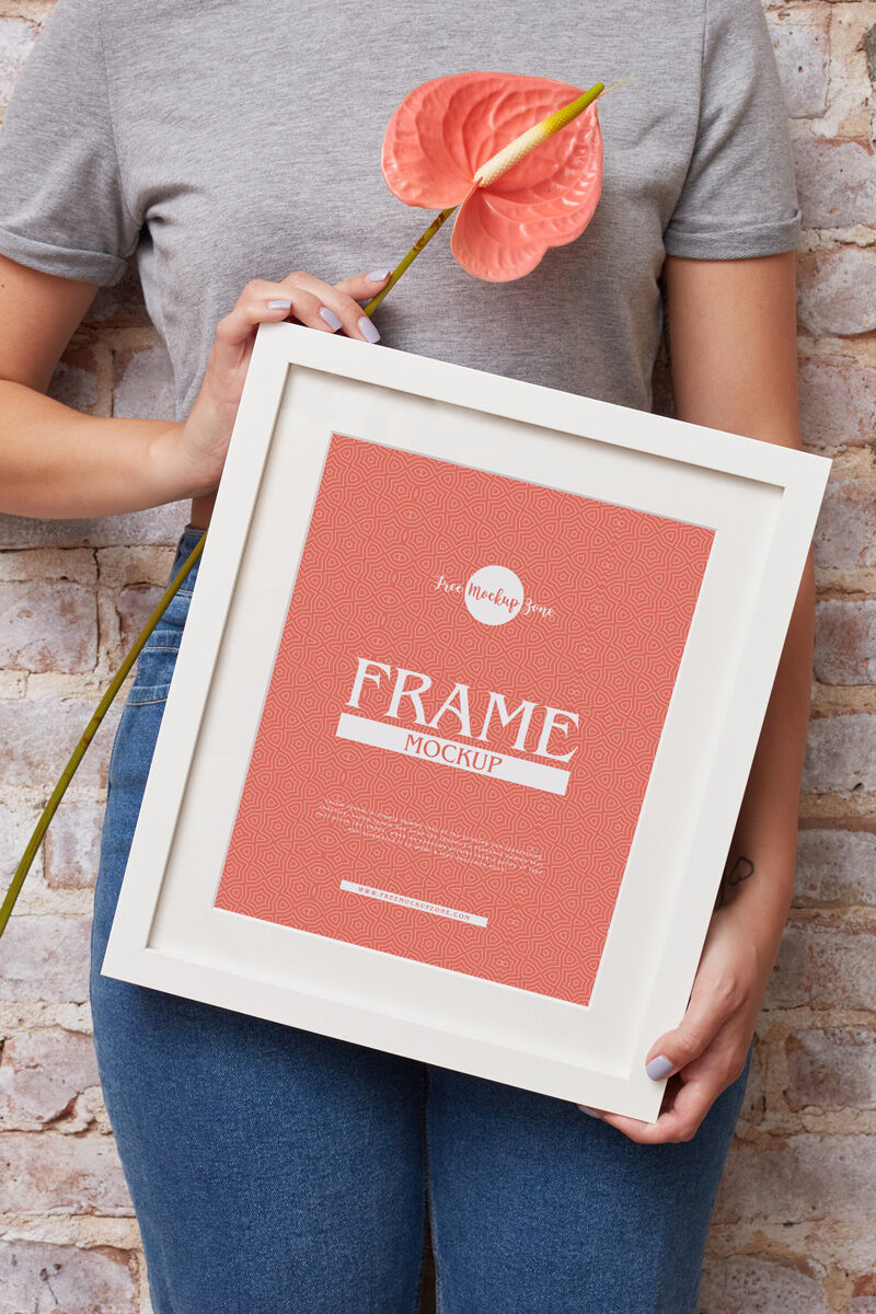 Vertical Photo Frame Mockup Featuring a Girl Holding it Diagonally FREE PSD