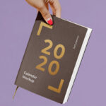 Woman Holding a Notebook / Calendar Mockup