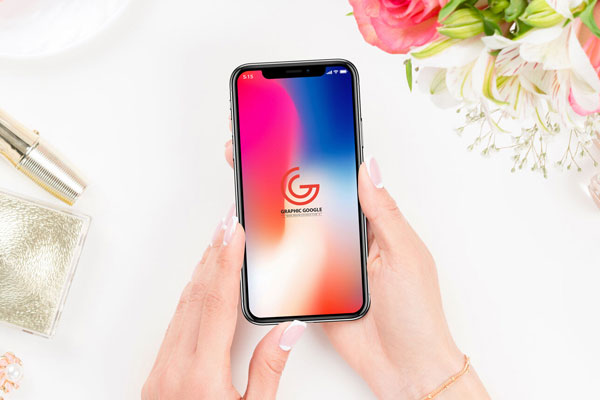Woman Holding iPhone X Over a Dressing Table Mockup