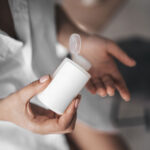 Woman Holding Realistic Mini Bottle Mockup from Top View