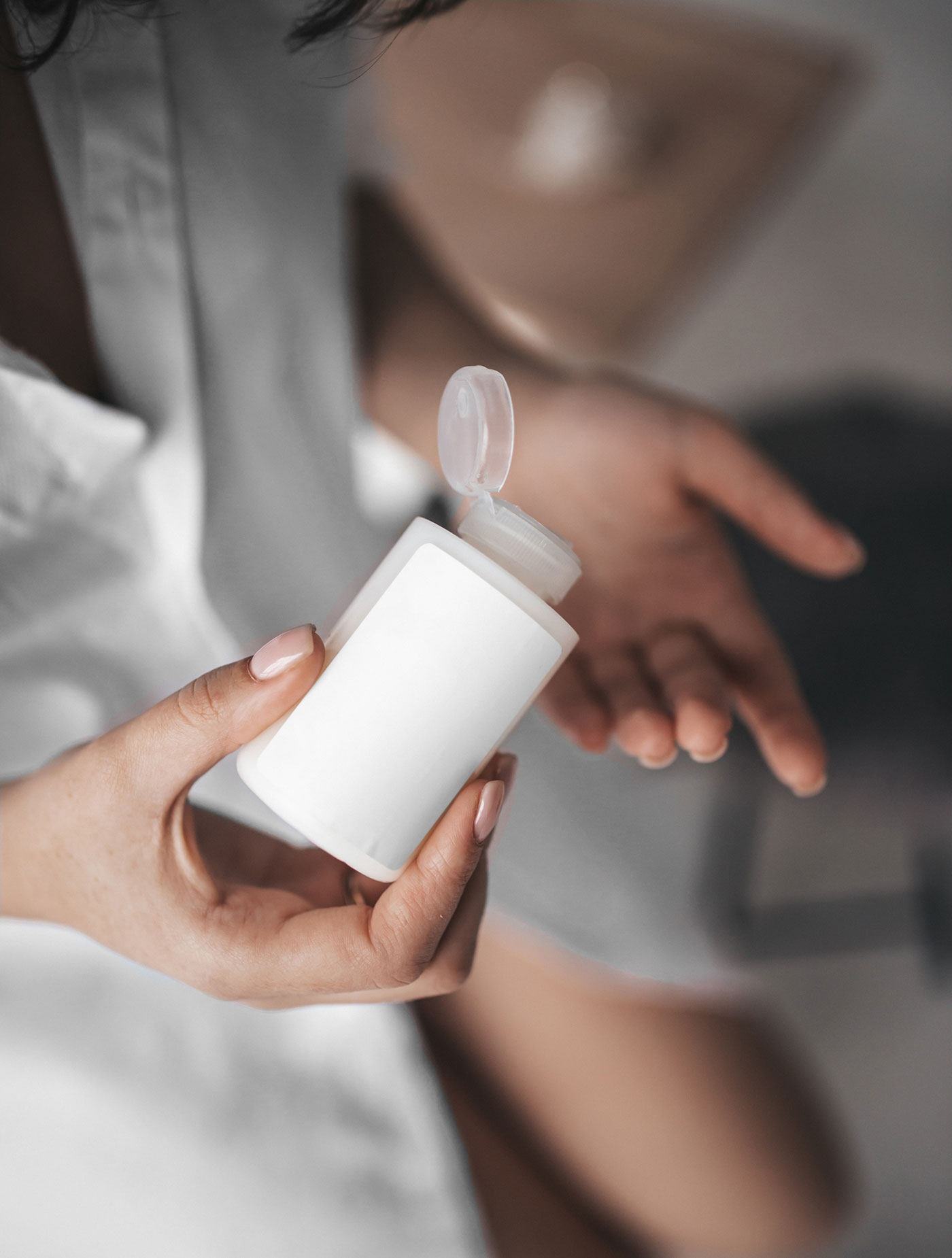Woman Holding Realistic Mini Bottle Mockup from Top View FREE PSD