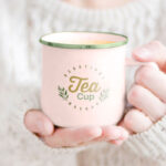 Woman Holding Tea Mug in Hand Mockup